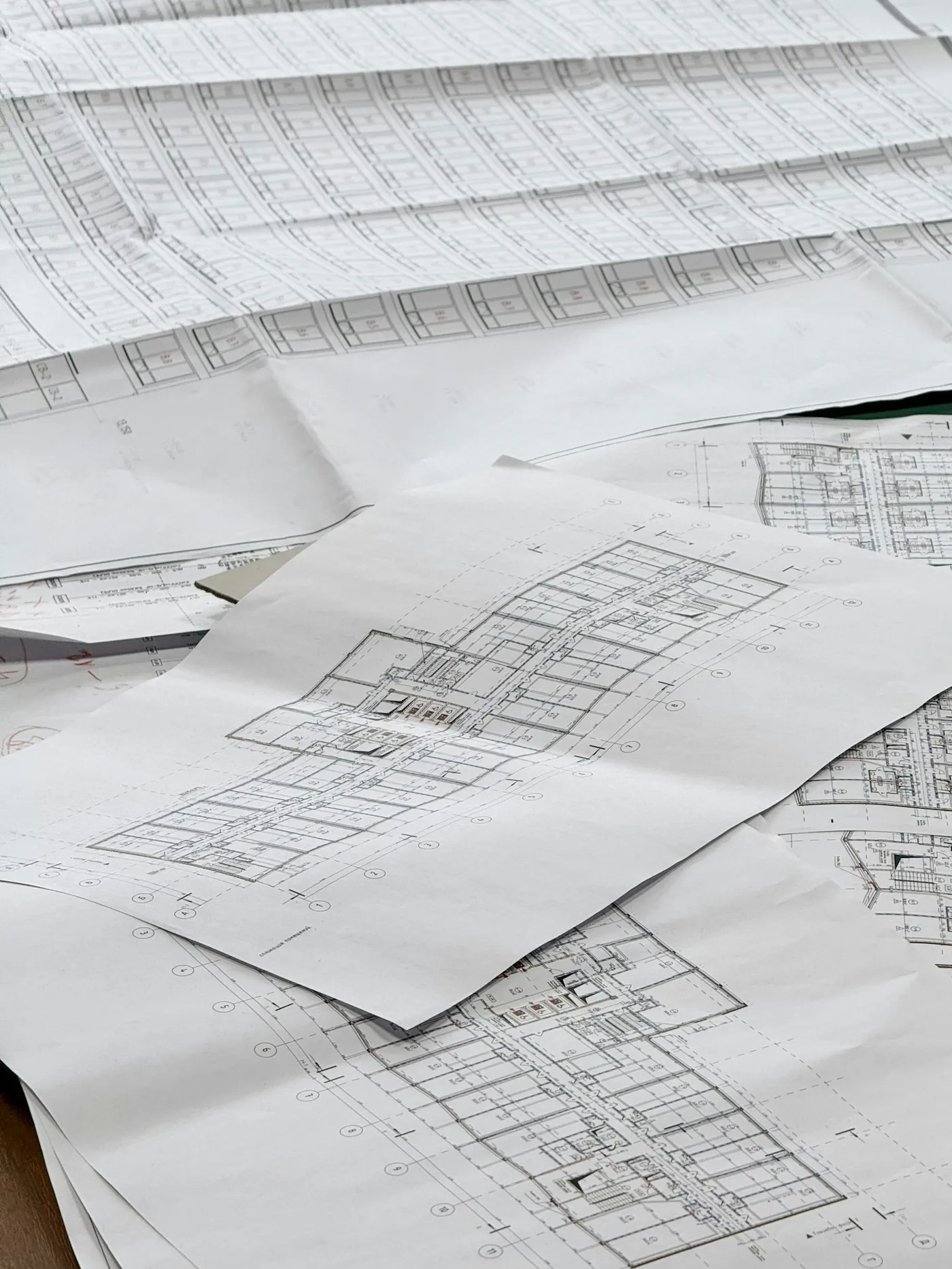Architectural blueprints and floor plans spread out on a table