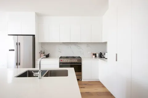 Contemporary minimal kitchen with white cabinets